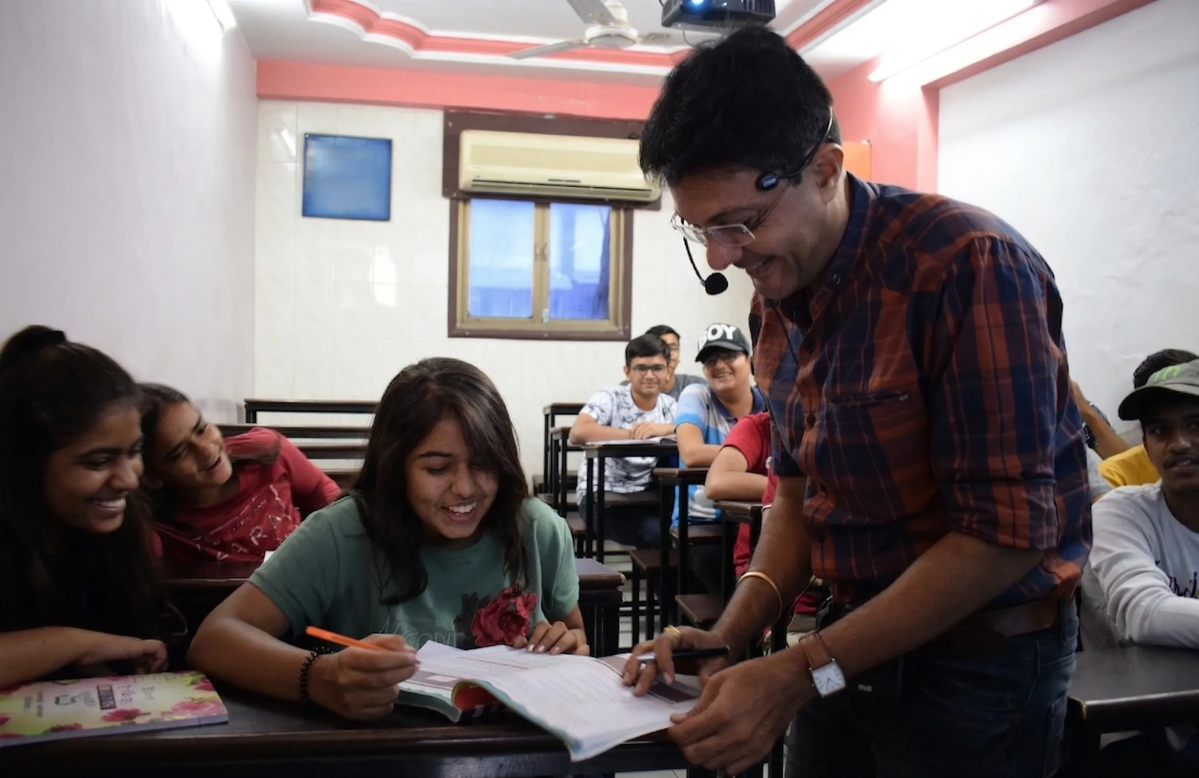 Celebration Moment: Students and Divyakant Sir celebrating success in Surat at ECWDS computer classes, Surat